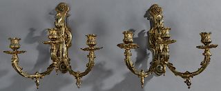 Pair of French Bronze Louis XC Style Three Light Brass Wall Sconces, late 19th c., the shaped back plate issuing three relief scrolled arms with gasco