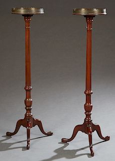 Pair of Queen Anne Style Carved Mahogany Torcheres, 20th c., the circular tops with pierced brass galleries, on tapered fluted supports to tripodal ba