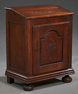 French Louis XIV Style Carved Walnut Slant Front Desk, 19th c., the serpentine lid opening to an inset gilt tooled magenta leather writing surface to 