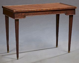 Carved Mahogany Games Table, c. 1900, the rectangular dished top opening to reveal a backgammon board with an inset gilt tooled brown leather, over a 