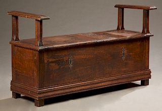 French Provincial Carved Oak Bench, early 19th c., the stepped flat arms over double lifting lids, over open storage, H.- 31 in., W.- 54 in., D.- 20 i