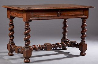 French Provincial Carved Walnut Writing Table, 18th c., the stepped edge rectangular top over a long frieze drawer on rope twist legs with turned and 