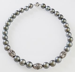 Strand of 30 Black Tahitian Cultured Pearls, ranging from 11.5 mm to 13.5 mm, with three sterling enhancers mounted with thirty-six tablet cut "illusi