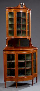 English Banded Mahogany Corner Cabinet c. 1910, the broken arch crown over a curved mullioned glazed door flanked by mullioned concave glazed panels o