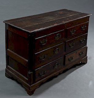 English Carved Oak Mule Chest, 19th c., the stepped lid over a front with four faux drawers over two bottom drawers on a plinth base on bracket feet, 