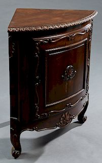 French Louis XV Style Carved Walnut Corner Cabinet, late 19th c., the gadrooned edge curved top over a large fielded panel convex cupboard door with a