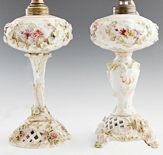 Pair of Meissen Style Porcelain Lamps, early 20th c., in the form of oil lamps, with floral encrusted decoration, the round "font" on a tapered relief