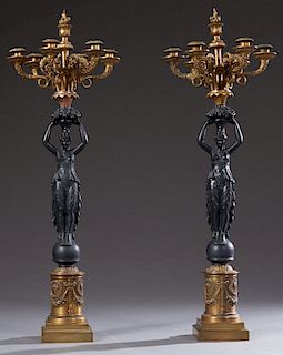 Pair of French Empire Style Gilt and Patinated Spelter Seven Light Candelabra, 20th c., the seven lights atop fruit baskets on the heads of classicall