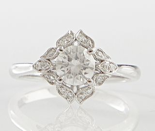 Lady's 18K White Gold Dinner Ring, the square top with a central .72 carat round diamond, atop a border of small round diamonds, diamond accent weight