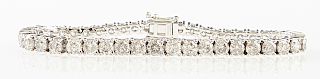 14K White Gold Tennis Bracelet, each of the 44 links with a graduated round diamond, total diamond weight- 12.07 cts., L.- 7 1/8 in., with appraisal.