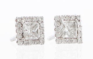 Pair of 14K White Gold Diamond Stud Earrings, the square screwback studs with a central .5 carat princess cut diamond, atop a border of small round di