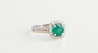 Lady's 14K White Gold Dinner Ring, with a 1.21 carat oval emerald atop a square border of round white diamonds, the shoulders of the bands with double