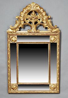 French Louis XVI Style Gilt and Gesso Overmantle Mirror, 19th c., with a pierced shell and floral basket scrolled crest over a relief scrolled frame e