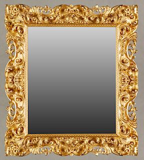 French Louis XV Style Gilt and Gesso Overmantle Mirror, late 19th c., the pierced deep relief scroll and leaf decorated frame around a rectangular pla