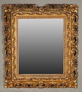 French Aesthetic Style Gilt and Gesso Overmantle Mirror, 19th c., the pierced scroll and leaf frame with floral corners around a gilt relief leaf and 