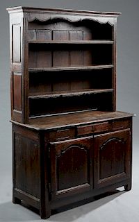 French Provincial Oak Buffet a Deux Corps, early 19th c., the upper section with a stepped crown over three open plate shelves, on a rounded corner ba