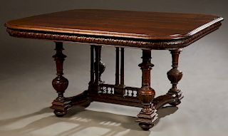 French Henri II Style Carved Walnut Dining Table, late 19th c. the rounded corner stepped edge top over a convex skirt, on turned tapered urn form tre