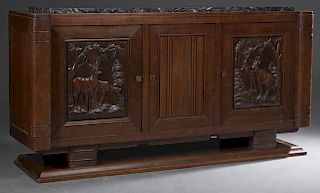 French Carved Walnut Art Deco Marble Top Sideboard, c. 1930, the highly figured black marble over two cupboard doors, carved with scenes of deer in a 