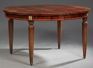 French Inlaid Ormolu Mounted Mahogany Dining Table, early 20th c., of oval form the beveled top over a banded ormolu mounted skirt, on tapered turned 