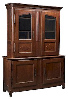 French Louis XV Style Carved Oak Buffet a Deux Corps, c. 1850, the rounded corner stepped cavetto crown above arched glazed paneled doors with iron es