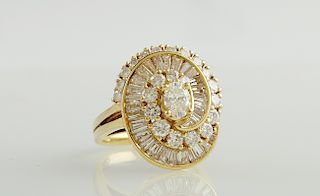 Lady's Vintage 18k Yellow Gold Dinner Ring, with a central 3/4 carat oval diamond atop a swirled border of graduated round diamonds and an inner borde