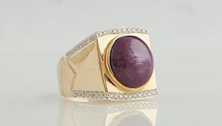 Man's 14K Yellow Gold Dinner Ring with an 11.28 carat oval cabochon star ruby on a tapering wide band with rhodium edges mounted with small round diam