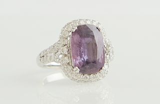 Lady's Platinum Dinner Ring, with a 7.81 carat cushion cut purple sapphire, atop a border of round diamonds, the split sides of the band also mounted 