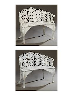 Pair of American Style Cast Iron Garden Benches, 20th c., the curved back with pierced floral decoration, to a pierced scrolled seat, flanked by arms 