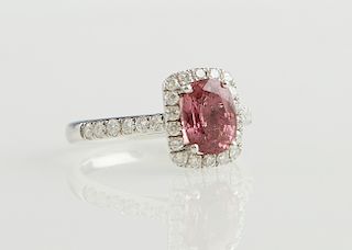 Lady's Platinum Dinner Ring, with an oval 1.98 carat pink sapphire atop a rectangular border of round diamonds, the sides of the band also mounted wit