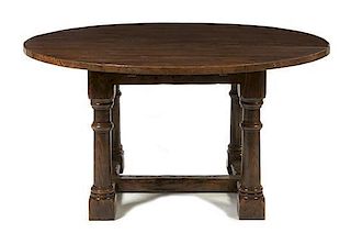 A Provincial Oak Dining Table, Height 30 1/4 x diameter 60 inches.