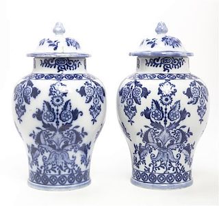 A Pair of Dutch Blue and White Lidded Urns, Height overall 12 1/2 inches.