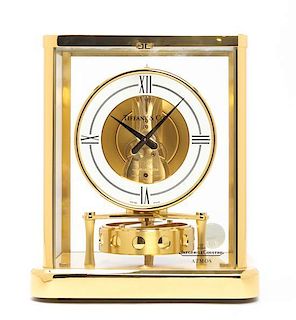 A Le Coultre Brass and Glass Atmos Clock, retailed by Tiffany & Co., Height 9 inches.