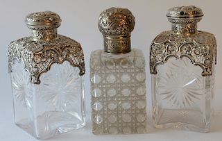 Three crystal bottles with silver tops. 
height 6 1/2 inches 
***If this lot is not picked up on Sat. 9/22, Sun. 9/23, or Tues 9/25 ...