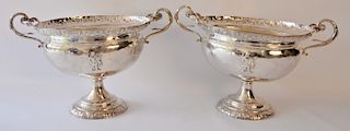 Pair of silver urns each with handles on round footed base. 
height 8 1/2 inches, width 13 1/2 inches, 49 troy ounces 
***If this lo...