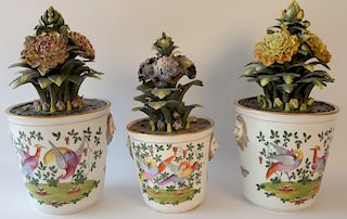 Three piece lot including a pair of porcelain urns with porcelain sprouting flowers having faces on sides and another near matching ...