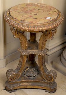 Baroque style gilt stand with round marble top over triple supports on three sided base, 19th century. 
height 30 inches, diameter 2...