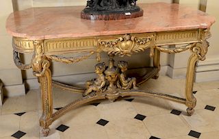 Gilt center table having shaped marble top over conforming base with swag floral decoration, set on four sided legs and having two s...