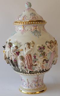 Porcelain urn with cover having three dimensional figures (chip on base and cover). 
height 16 inches 
***If this lot is not picked ...