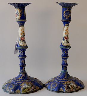 Pair of Staffordshire enamel candlesticks, 18th century, blue ground with scrolling gilt vines and hand painted landscape panels (as...