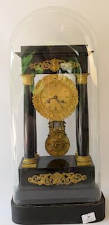 Empire mantle clock, ebonized wood with gilt bronze clock, pendulum, and mounts, under glass dome. 
total height 24 1/2 inches 
***I...