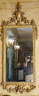 Continental style gilt mirror with urn top and large flowers (some old repairs). 
height 81 inches, width 34 inches 
***If this lot ...