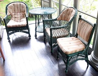 Seven pieces of antique Bar Harbor wicker to include chaise, three armchairs, one tall round table, low round side table, and one si...
