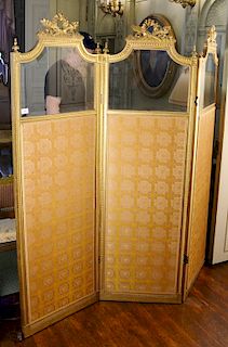 Louis XVI style gilt three fold dressing screen having shaped bevel glass tops over silk panels. 
height 71 1/4 inches, width 64 1/2...