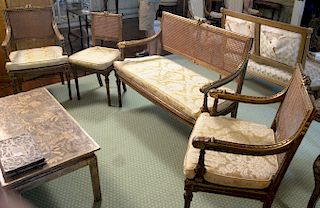 Four piece set including a pair of caned back armchairs, a side chair, and a settee, all set on turned legs (originally had caned se...