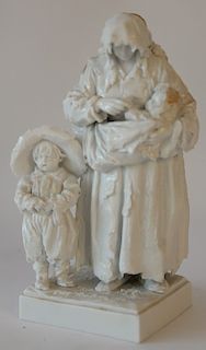 German porcelain figural group having hooded figure with three children, blue mark on bottom and round Christie's paper number. 
hei...