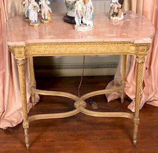 Gilt center table with shaped rouge marble top on conforming frieze set on twist turned legs with shaped stretchers. 
height 30 1/4 ...