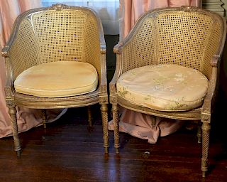 Pair of round back Louis XVI style chairs having caned seats and backs, all set on twist turned legs (seat caning as is). 
height 34...