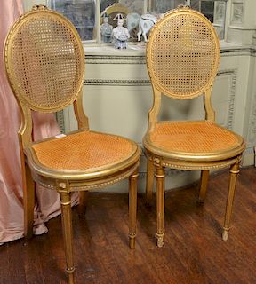 Pair of Louis XVI style gilt side chairs with caned seats and backs. 
total height 37 inches 
***If this lot is not picked up on Sat...