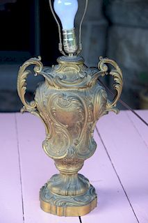 Large bronze urn made into a table lamp having scrolling foliate design, remnants of gold gilt. 
***If this lot is not picked up on ...