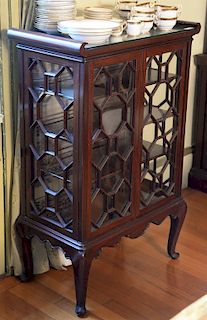 Pair of mahogany curio cabinets with two doors, each set on cabriole legs. 
height 42 inches, width 27 1/2 inches 
***If this lot is...